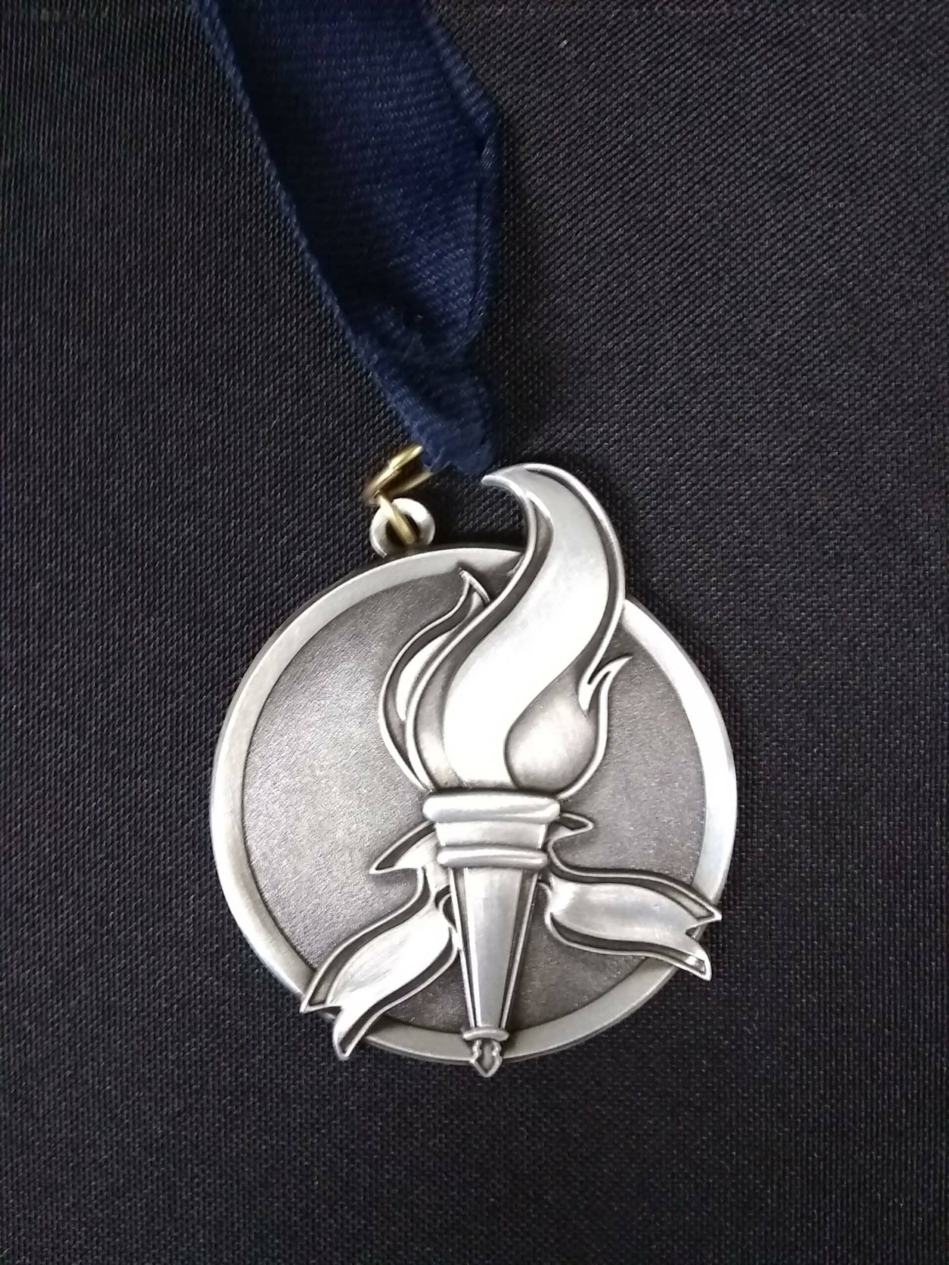 The Class 5 medal featuring a blazing torch.